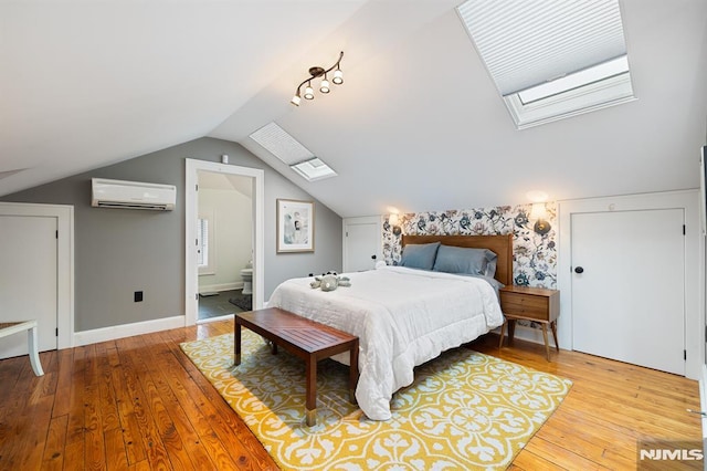206 Eastern Way, Rutherford, NJ 07070 - bedroom with a skylight, a wall unit AC, hardwood / wood-style floors, lofted ceiling, and ensuite bath