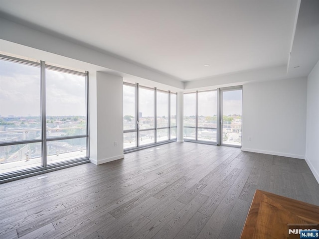 320 Adolphus Ave Unit 401, Cliffside Park, NJ 07010 - unfurnished room featuring dark wood-type flooring, baseboards, and plenty of natural light
