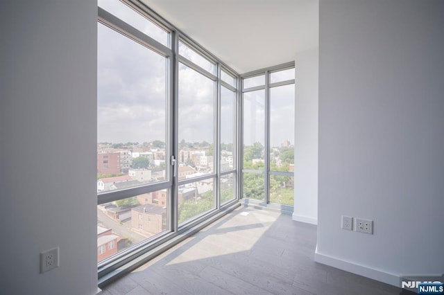 320 Adolphus Ave Unit 401, Cliffside Park, NJ 07010 - spare room featuring floor to ceiling windows, baseboards, wood finished floors, and a city view