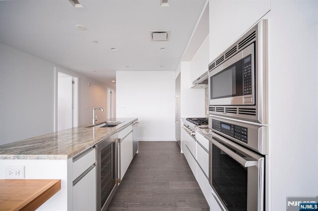 320 Adolphus Ave Unit 401, Cliffside Park, NJ 07010 - kitchen with stainless steel appliances, a sink, beverage cooler, modern cabinets, and white cabinetry