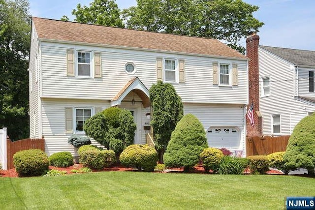 64 Lunn Ave, Bergenfield, NJ 07621 - colonial-style house featuring an attached garage
