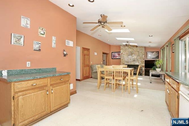64 Lunn Ave, Bergenfield, NJ 07621 - dining space featuring ceiling fan, a fireplace, and a skylight