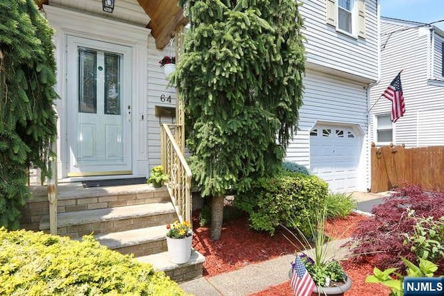 64 Lunn Ave, Bergenfield, NJ 07621 - view of exterior entry featuring an attached garage