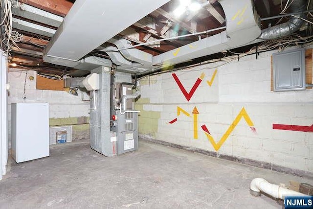 64 Lunn Ave, Bergenfield, NJ 07621 - unfinished basement featuring electric panel, heating unit, and white refrigerator