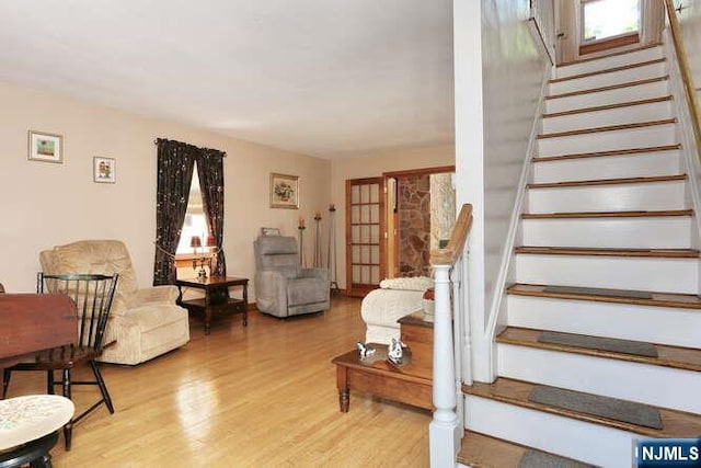 64 Lunn Ave, Bergenfield, NJ 07621 - living room featuring stairway, light wood-type flooring, and plenty of natural light