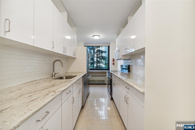 200 Winston Unit 121, Cliffside Park, NJ 07010 - kitchen featuring a sink, range, white cabinets, tasteful backsplash, and light tile patterned floors