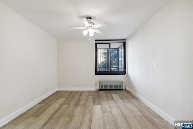 200 Winston Unit 121, Cliffside Park, NJ 07010 - empty room with light wood-style floors, ceiling fan, baseboards, and radiator heating unit