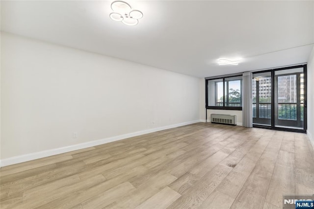 200 Winston Unit 121, Cliffside Park, NJ 07010 - unfurnished room featuring light wood-type flooring, baseboards, and radiator