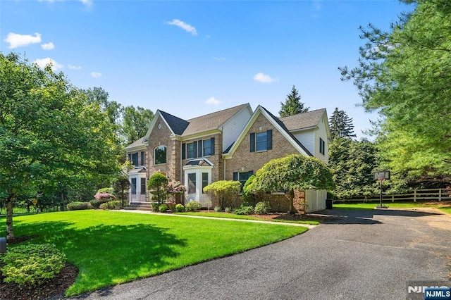 4 Michelle Ct, Harrington Park, NJ 07640 - colonial-style house featuring a front yard, asphalt driveway, and brick siding