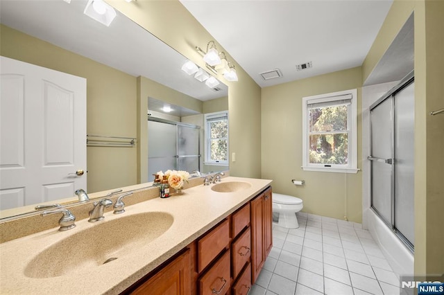 4 Michelle Ct, Harrington Park, NJ 07640 - bathroom featuring toilet, double vanity, tile patterned floors, and enclosed tub / shower combo