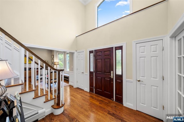 4 Michelle Ct, Harrington Park, NJ 07640 - foyer featuring stairs, wood finished floors, a towering ceiling, wainscoting, and ornamental molding