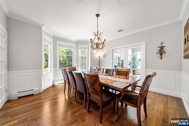 4 Michelle Ct, Harrington Park, NJ 07640 - dining space featuring a baseboard heating unit, a chandelier, healthy amount of natural light, wood finished floors, and a wainscoted wall