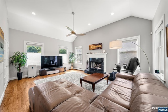 4 Michelle Ct, Harrington Park, NJ 07640 - living room with vaulted ceiling, a ceiling fan, a high end fireplace, light wood-type flooring, and baseboard heating