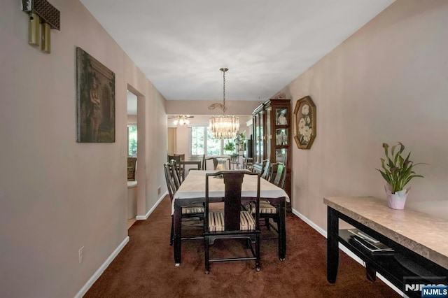 42 Lohs Pl, Harrington Park, NJ 07640 - dining space with dark colored carpet, a chandelier, and baseboards