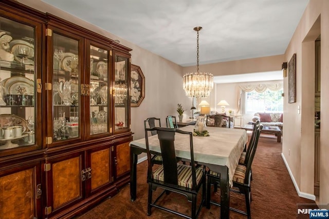 42 Lohs Pl, Harrington Park, NJ 07640 - dining room featuring dark colored carpet, a chandelier, and baseboards