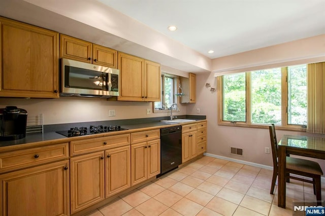 42 Lohs Pl, Harrington Park, NJ 07640 - kitchen with black appliances, a sink, light tile patterned flooring, baseboards, and dark countertops