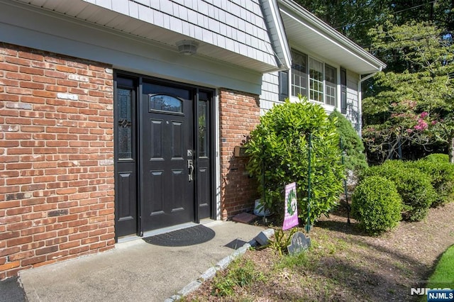 42 Lohs Pl, Harrington Park, NJ 07640 - view of exterior entry with brick siding and mansard roof