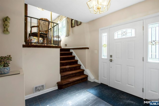42 Lohs Pl, Harrington Park, NJ 07640 - entryway with stairs, baseboards, tile patterned flooring, and a chandelier