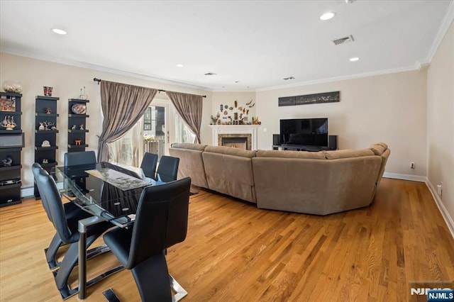 1464 River Rd Unit 1, Edgewater, NJ 07020 - living area featuring crown molding, light wood finished floors, a lit fireplace, recessed lighting, and baseboards