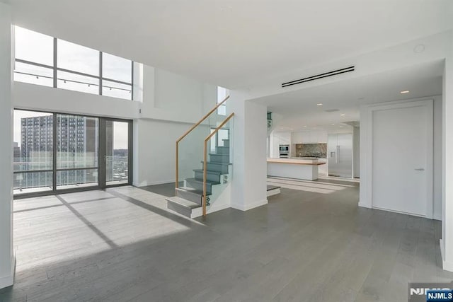 320 Adolphus Ave Unit 1115, Cliffside Park, NJ 07010 - unfurnished living room with wood finished floors, stairs, baseboards, and recessed lighting