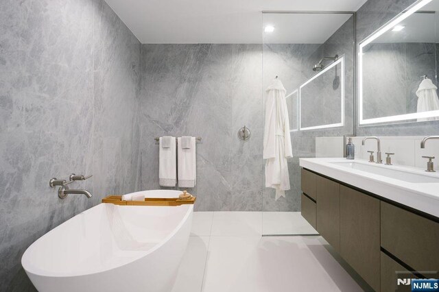 320 Adolphus Ave Unit 1115, Cliffside Park, NJ 07010 - full bathroom featuring vanity, tile walls, a soaking tub, and a walk in shower