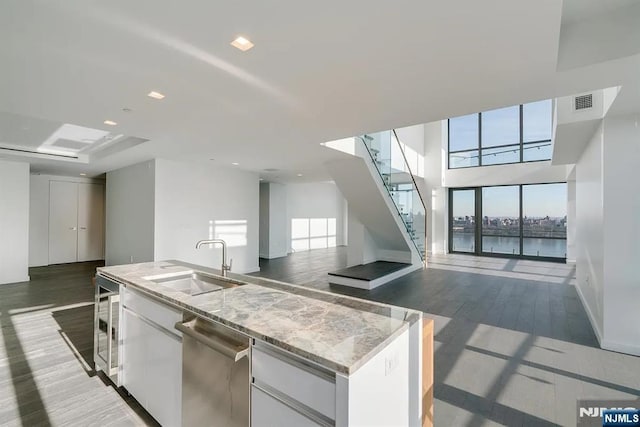 320 Adolphus Ave Unit 1115, Cliffside Park, NJ 07010 - kitchen with a sink, open floor plan, beverage cooler, wood finished floors, and dishwasher