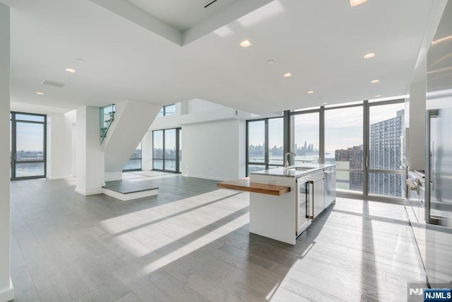 320 Adolphus Ave Unit 1115, Cliffside Park, NJ 07010 - kitchen featuring healthy amount of natural light, wood finished floors, open floor plan, and floor to ceiling windows