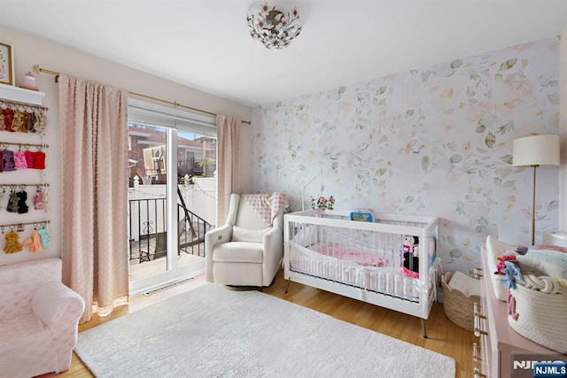 6 Gail Pl, Secaucus, NJ 07094 - bedroom with wallpapered walls, wood finished floors, and access to exterior