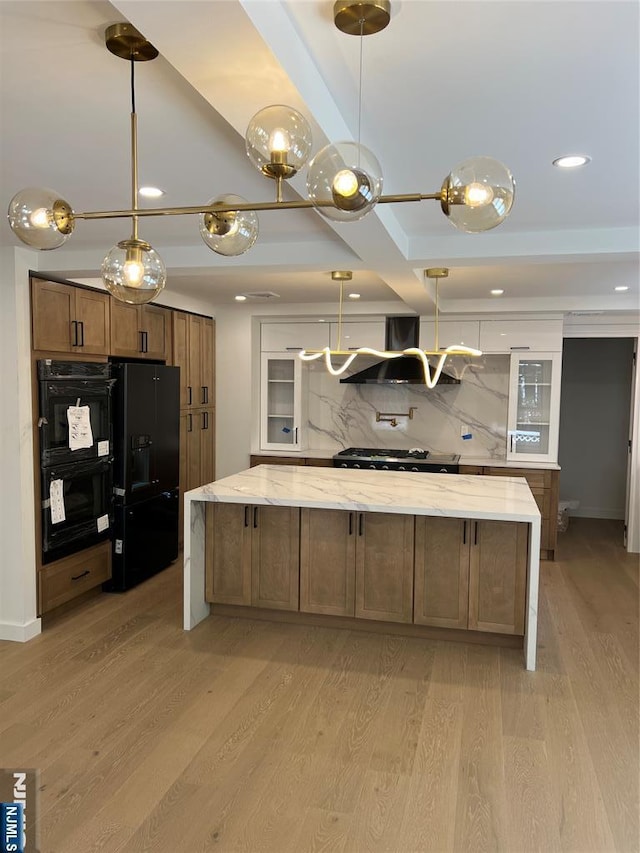 397 Knickerbocker Rd, Tenafly, NJ 07670 - kitchen with black appliances, exhaust hood, light wood-type flooring, backsplash, and light stone counters