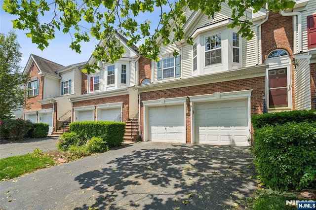 315 Winthrop Dr Unit 3082, Nutley, NJ 07110 - view of property featuring a garage, brick siding, and driveway