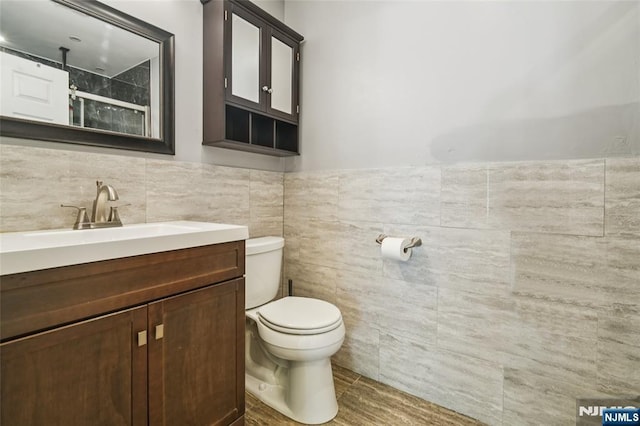 315 Winthrop Dr Unit 3082, Nutley, NJ 07110 - bathroom featuring toilet, vanity, tile walls, a shower, and a wainscoted wall