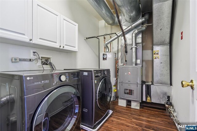 315 Winthrop Dr Unit 3082, Nutley, NJ 07110 - washroom featuring separate washer and dryer, dark wood finished floors, cabinet space, and water heater