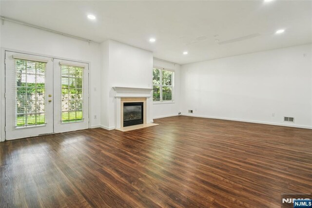 315 Winthrop Dr Unit 3082, Nutley, NJ 07110 - unfurnished living room with wood finished floors, french doors, a fireplace with flush hearth, recessed lighting, and baseboards