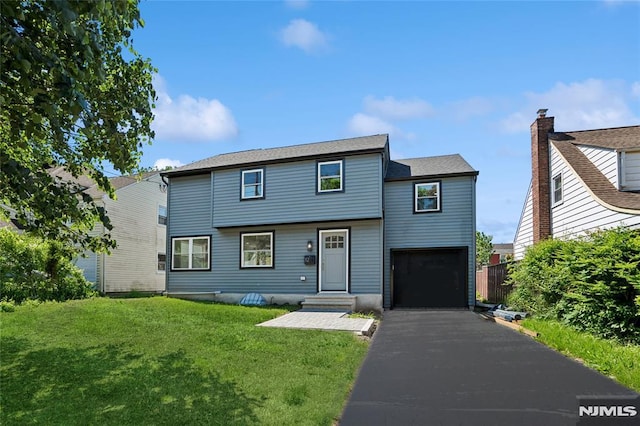 12 Armory Pl, Teaneck, NJ 07666 - view of front of home featuring a front lawn, driveway, and an attached garage