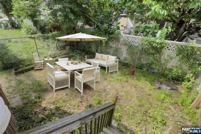 215 48th St Unit 101, Union City, NJ 07087 - fenced backyard with outdoor lounge area and outdoor dining space