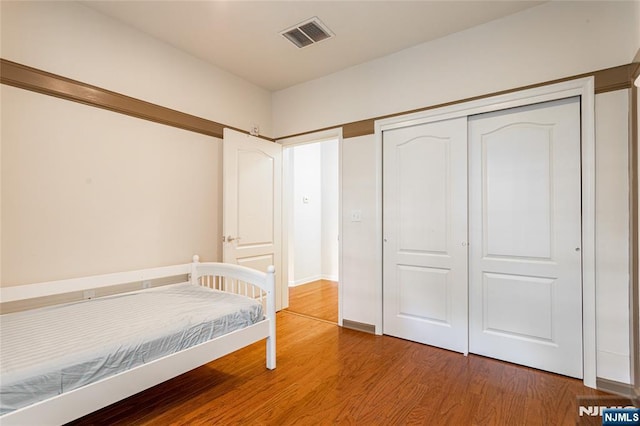 40 Azalea Dr, Old Bridge, NJ 08857 - bedroom with wood finished floors, a closet, and baseboards