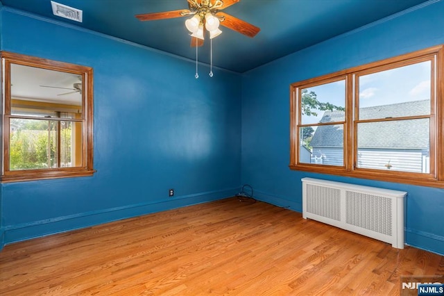 211 Harrison Ave, Hasbrouck Heights, NJ 07604 - spare room with radiator heating unit, ceiling fan, light wood finished floors, and ornamental molding