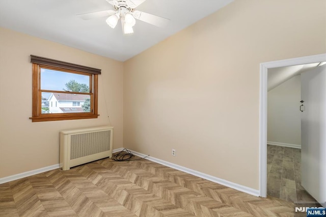 211 Harrison Ave, Hasbrouck Heights, NJ 07604 - empty room with radiator heating unit, a ceiling fan, and vaulted ceiling