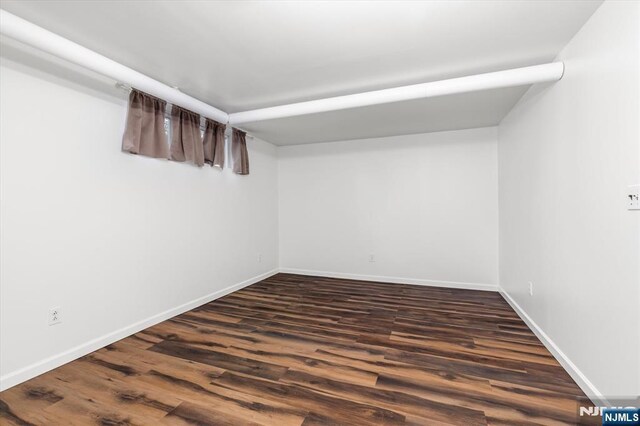 211 Harrison Ave, Hasbrouck Heights, NJ 07604 - finished below grade area featuring dark wood finished floors and baseboards