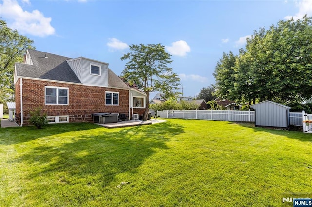 211 Harrison Ave, Hasbrouck Heights, NJ 07604 - rear view of property with a jacuzzi, a fenced backyard, a shed, a patio area, and brick siding