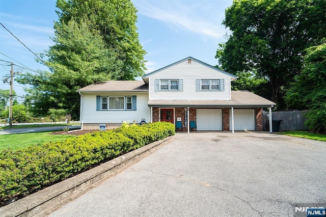 3 High St, Closter, NJ 07624 - split level home featuring asphalt driveway, an attached garage, and brick siding