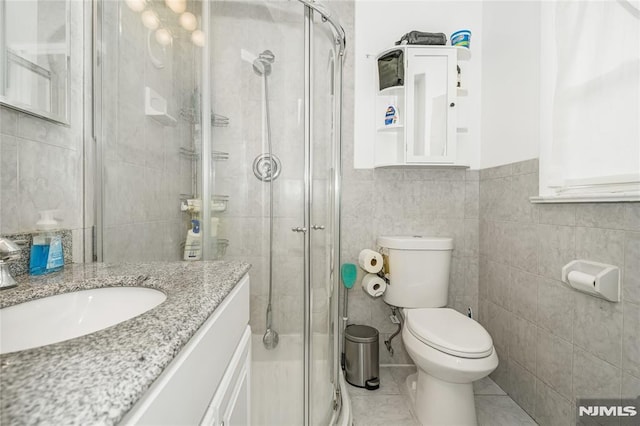 3 High St, Closter, NJ 07624 - full bathroom with tile walls, vanity, a shower stall, and tile patterned floors