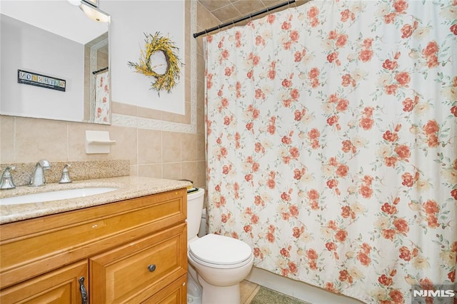 3 High St, Closter, NJ 07624 - bathroom featuring vanity, curtained shower, tile walls, and decorative backsplash