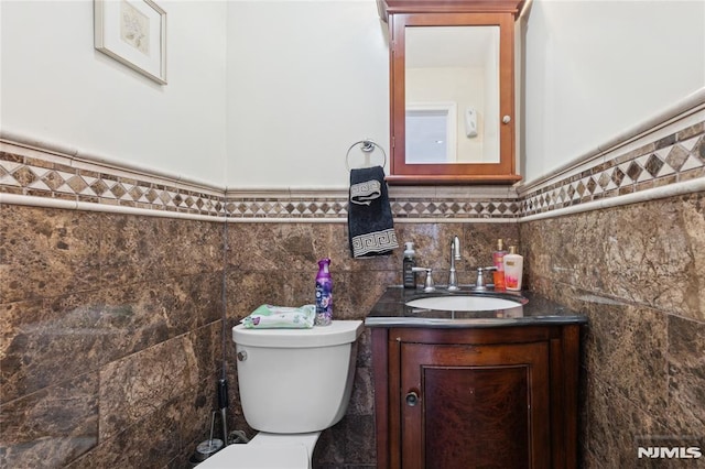205 Summit Ave, Bogota, NJ 07603 - half bath featuring vanity, wainscoting, and tile walls