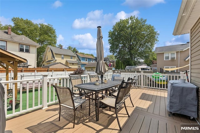 205 Summit Ave, Bogota, NJ 07603 - wooden terrace featuring outdoor dining area, a residential view, and a fenced backyard