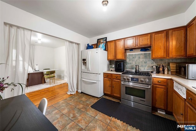 303-305 Runyon St, Newark, NJ 07108 - kitchen with stainless steel appliances, light countertops, decorative backsplash, and brown cabinets