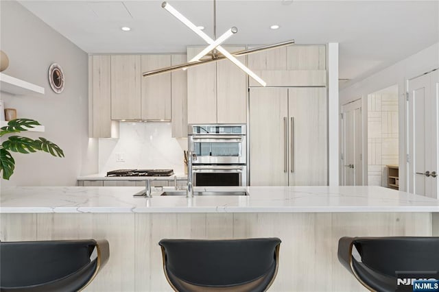 800 Ave At Port Imperial Blvd Unit 517, Weehawken, NJ 07086 - kitchen with double oven, a kitchen bar, light stone counters, decorative backsplash, and recessed lighting