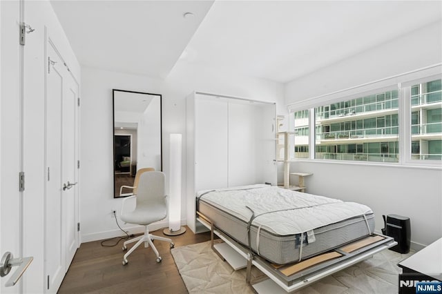 800 Ave At Port Imperial Blvd Unit 517, Weehawken, NJ 07086 - bedroom with wood finished floors, a closet, and baseboards