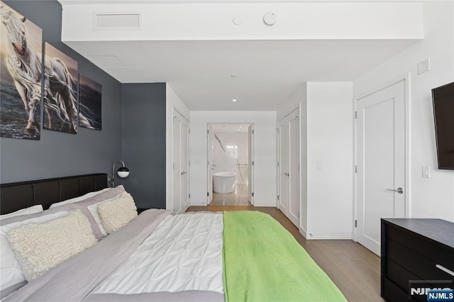 800 Ave At Port Imperial Blvd Unit 517, Weehawken, NJ 07086 - bedroom with wood finished floors, ensuite bathroom, and recessed lighting