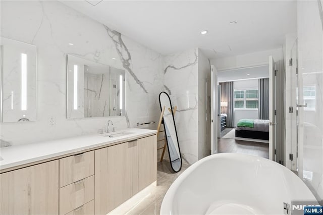 800 Ave At Port Imperial Blvd Unit 517, Weehawken, NJ 07086 - ensuite bathroom featuring a freestanding tub, vanity, and a marble finish shower